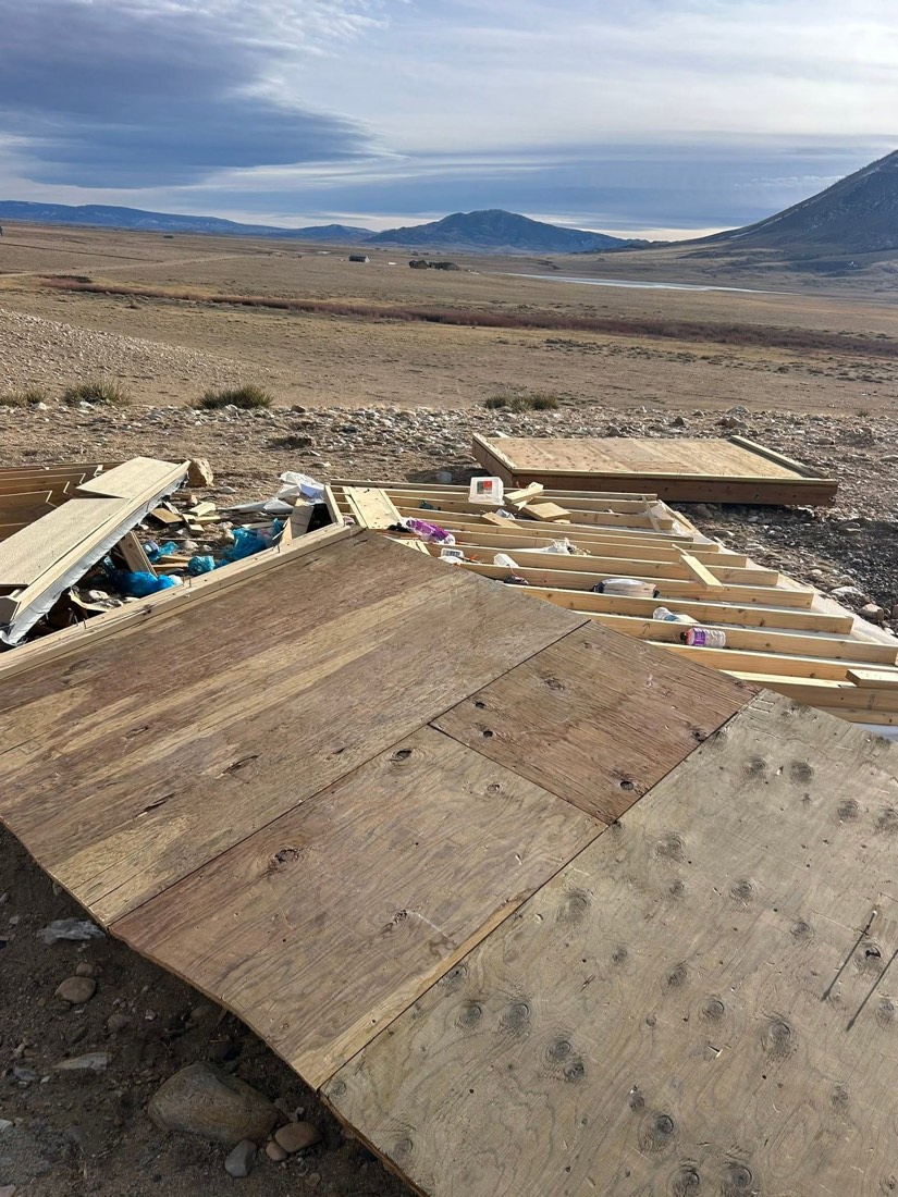 Property debris ready for removal in a Wyoming landscape
