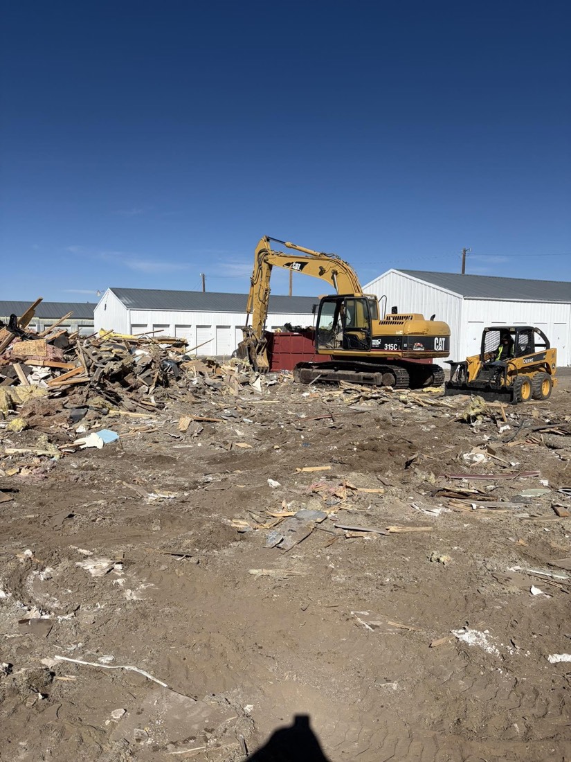 Excavator clearing a demolition site