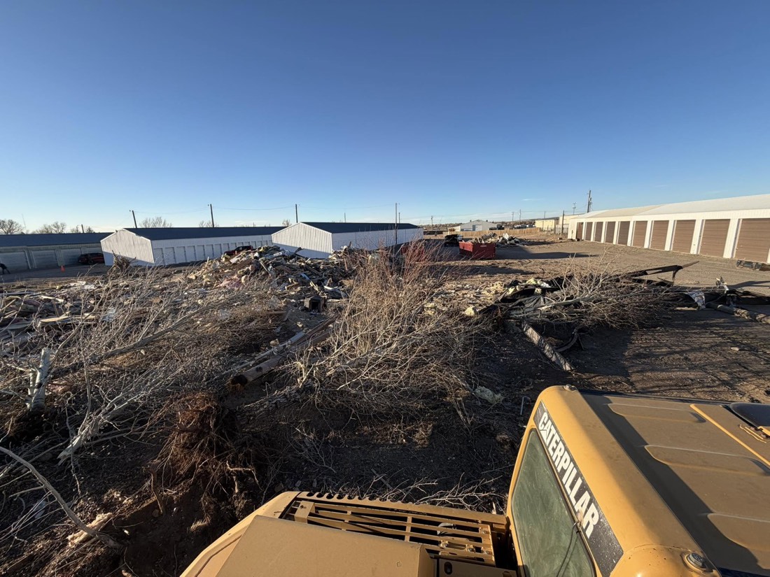 Demolition debris being cleared with heavy equipment