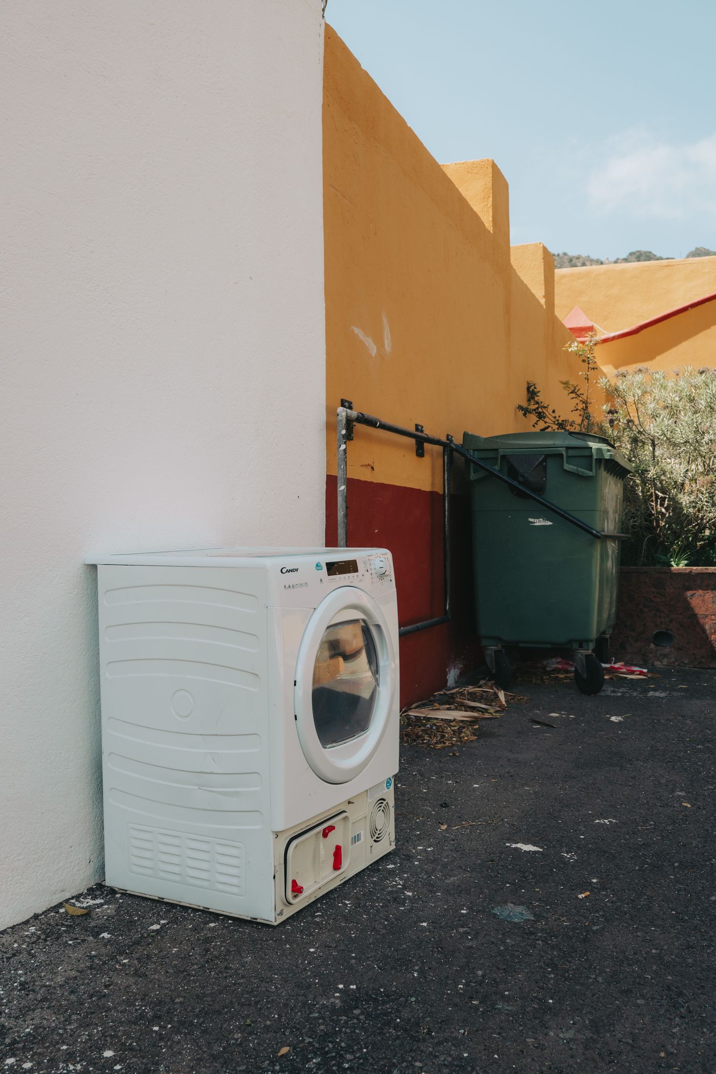 Discarded washing machine ready for removal
